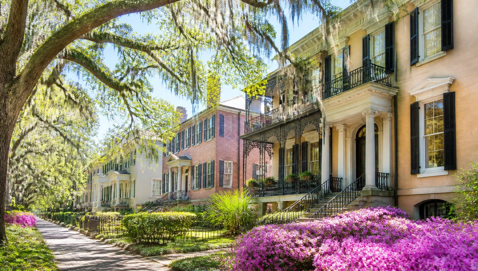 Savannah historic square at golden hour with live oaks, Spanish moss, and brick rowhouses